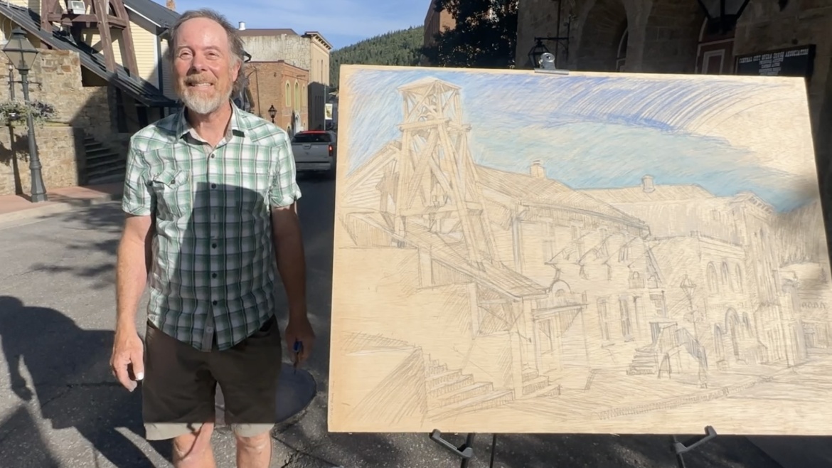 picture of Jonathan Machen with a plein-air drawing he made in Central City, CO