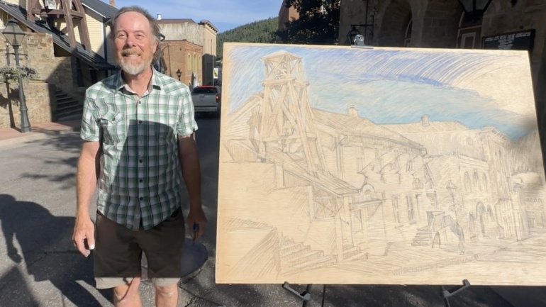 picture of Jonathan Machen with a plein-air drawing he made in Central City, CO