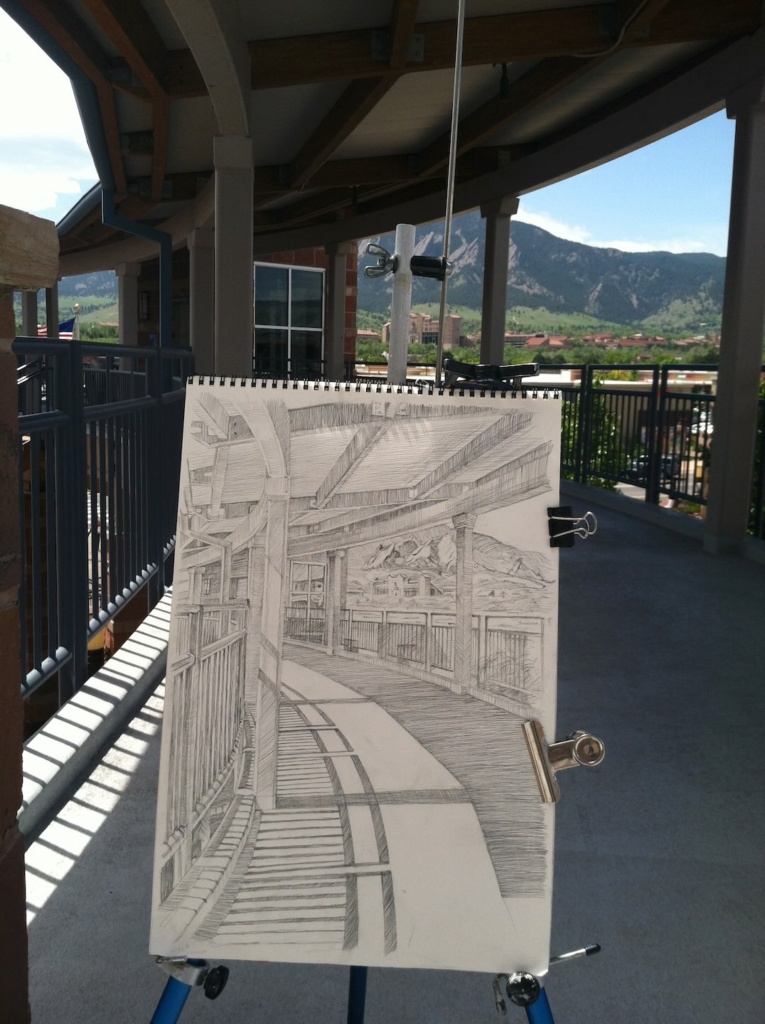a photo of a drawing by Jonathan Machen, showing Folsom Field and the flatirons from the upper walkway of the 29th st Mall in Boulder.
